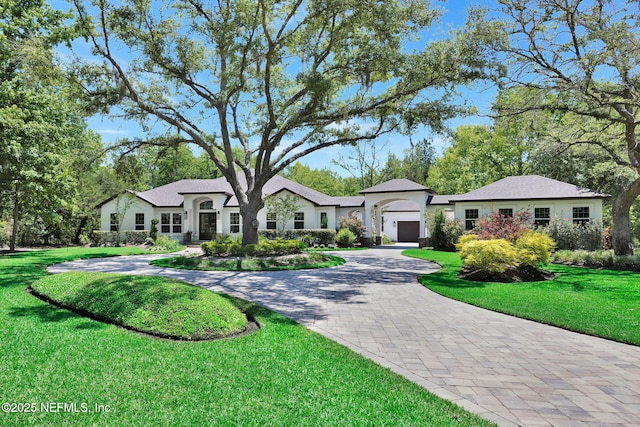 2790 Joe Ashton Rd, Saint Augustine, FL 32092 - single story home featuring a garage, curved driveway, a front yard, and stucco siding