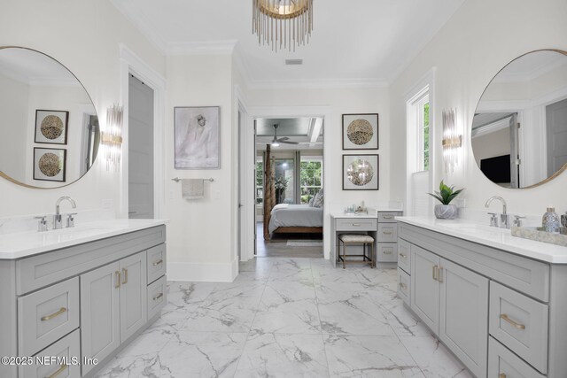 2790 Joe Ashton Rd, Saint Augustine, FL 32092 - ensuite bathroom with two vanities, ceiling fan, marble finish flooring, crown molding, and baseboards
