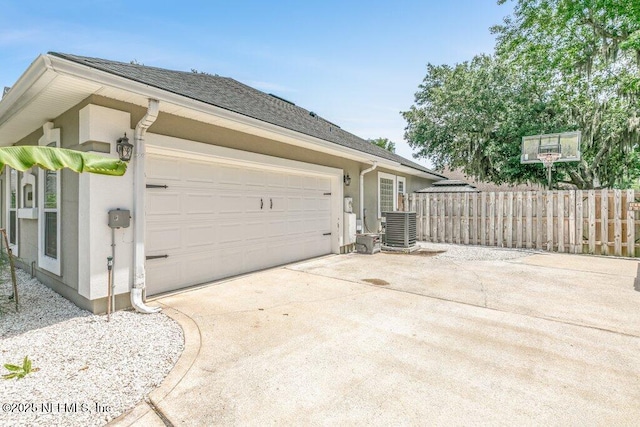 2918 Grande Oaks Way, Fleming Island, FL 32003 - view of home's exterior with central AC unit, stucco siding, concrete driveway, and an attached garage