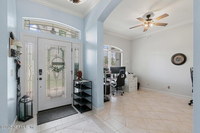 2918 Grande Oaks Way, Fleming Island, FL 32003 - entryway with arched walkways, ceiling fan, light tile patterned flooring, baseboards, and crown molding
