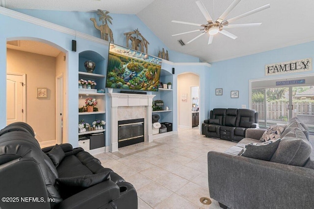2918 Grande Oaks Way, Fleming Island, FL 32003 - living area with arched walkways, lofted ceiling, built in shelves, light tile patterned floors, and ceiling fan