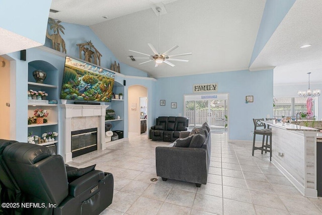 2918 Grande Oaks Way, Fleming Island, FL 32003 - living room featuring ceiling fan, built in shelves, a tile fireplace, plenty of natural light, and lofted ceiling