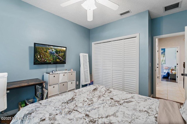 2918 Grande Oaks Way, Fleming Island, FL 32003 - bedroom with a closet, a ceiling fan, and a textured ceiling