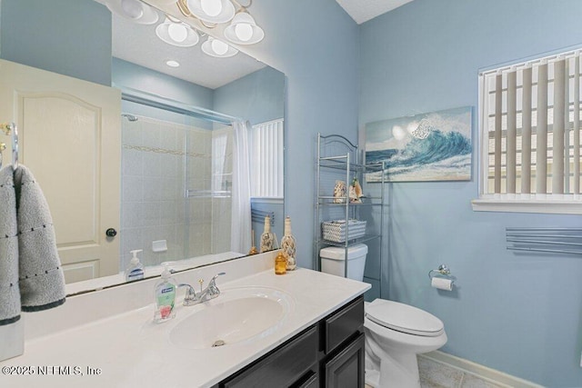 2918 Grande Oaks Way, Fleming Island, FL 32003 - bathroom with vanity, toilet, a tile shower, tile patterned floors, and baseboards