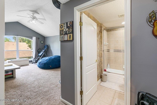 2918 Grande Oaks Way, Fleming Island, FL 32003 - hall with a textured ceiling, vaulted ceiling, carpet, tile patterned floors, and baseboards