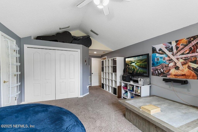 2918 Grande Oaks Way, Fleming Island, FL 32003 - carpeted bedroom with vaulted ceiling, a closet, ceiling fan, and a textured ceiling