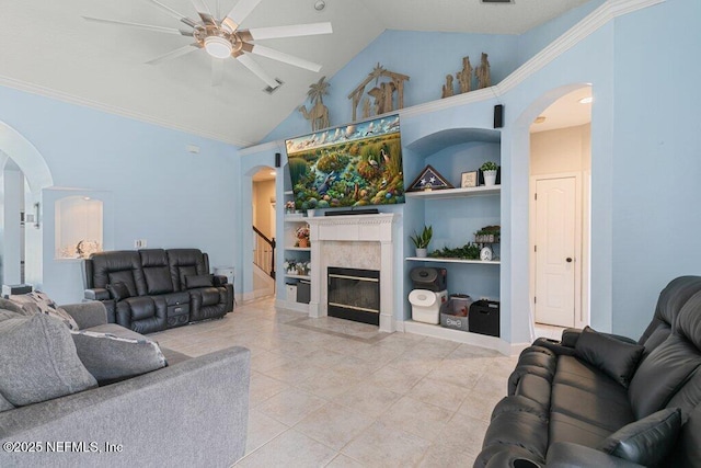 2918 Grande Oaks Way, Fleming Island, FL 32003 - living area featuring arched walkways, a ceiling fan, built in shelves, light tile patterned flooring, and a fireplace