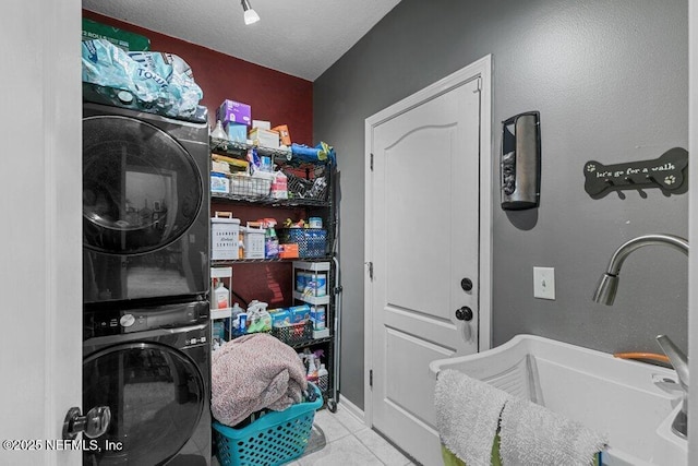 2918 Grande Oaks Way, Fleming Island, FL 32003 - washroom with estacked washer and dryer and tile patterned floors