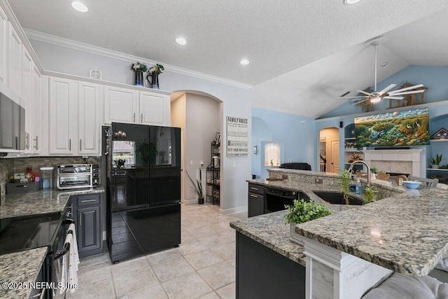2918 Grande Oaks Way, Fleming Island, FL 32003 - kitchen featuring black appliances, a sink, arched walkways, a ceiling fan, and white cabinetry