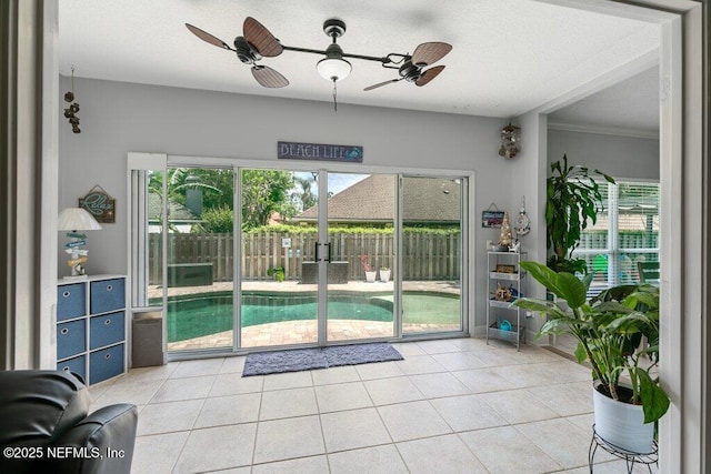 2918 Grande Oaks Way, Fleming Island, FL 32003 - doorway featuring light tile patterned floors, ceiling fan, and crown molding