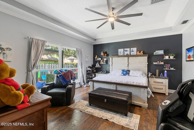 2918 Grande Oaks Way, Fleming Island, FL 32003 - bedroom featuring a raised ceiling, dark wood-style floors, and a ceiling fan
