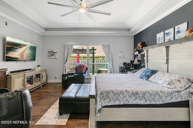 2918 Grande Oaks Way, Fleming Island, FL 32003 - bedroom featuring a tray ceiling, wood finished floors, ornamental molding, baseboards, and a ceiling fan