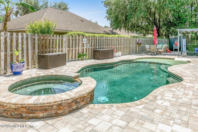 2918 Grande Oaks Way, Fleming Island, FL 32003 - view of pool featuring a patio area, a fenced backyard, and a pool with connected hot tub