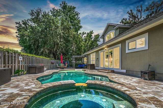 2918 Grande Oaks Way, Fleming Island, FL 32003 - pool at dusk with a patio area and a pool with connected hot tub