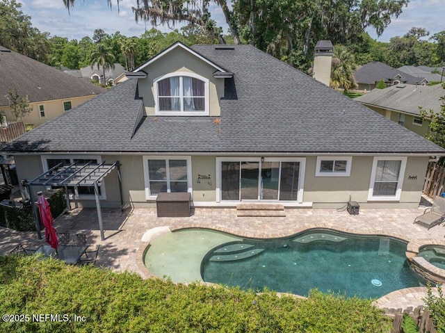 2918 Grande Oaks Way, Fleming Island, FL 32003 - back of property with a shingled roof, stucco siding, a pergola, a chimney, and a pool with connected hot tub