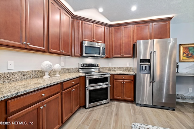 271 Roaring Brook Dr, Saint Augustine, FL 32084 - kitchen with appliances with stainless steel finishes, light wood-style floors, light stone counters, and recessed lighting
