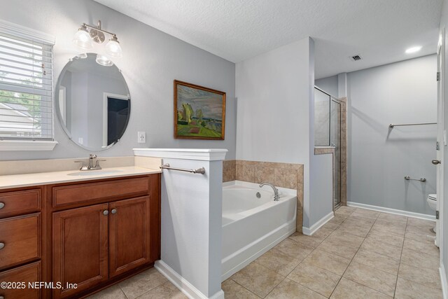 271 Roaring Brook Dr, Saint Augustine, FL 32084 - bathroom with a garden tub, vanity, a stall shower, tile patterned flooring, and toilet