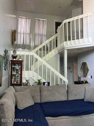 1188 Fromage Way, Jacksonville, FL 32225 - living room featuring stairway and a towering ceiling