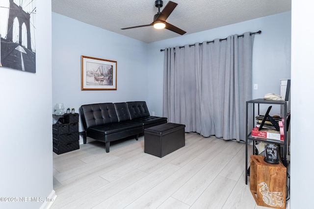 1188 Fromage Way, Jacksonville, FL 32225 - living room featuring light wood-style flooring, ceiling fan, and a textured ceiling