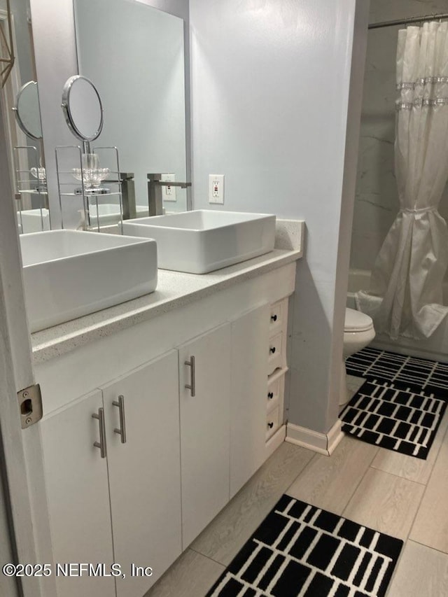 1188 Fromage Way, Jacksonville, FL 32225 - bathroom featuring double vanity, toilet, wood finished floors, and shower / bath combination with curtain