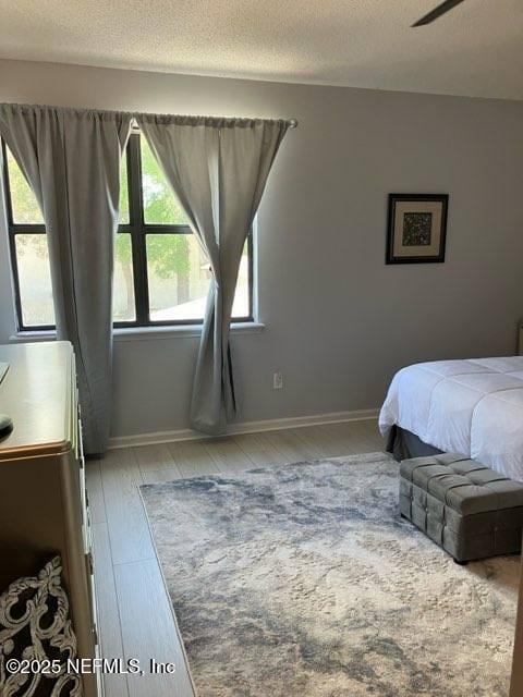 1188 Fromage Way, Jacksonville, FL 32225 - bedroom featuring wood finished floors, a textured ceiling, and baseboards