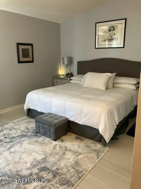 1188 Fromage Way, Jacksonville, FL 32225 - bedroom featuring wood finished floors and vaulted ceiling