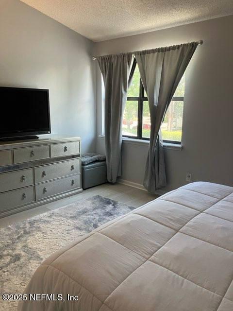 1188 Fromage Way, Jacksonville, FL 32225 - bedroom with a textured ceiling and baseboards
