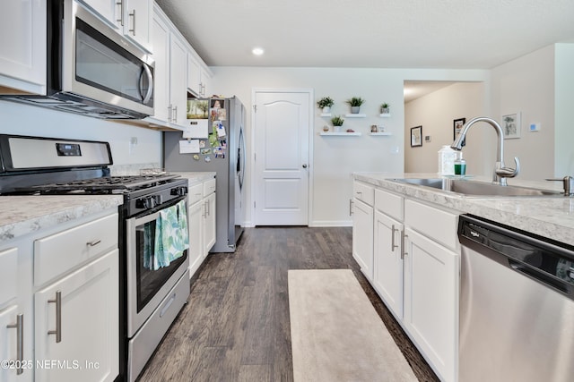 36 Grand Par Ct, Bunnell, FL 32110 - kitchen featuring stainless steel appliances, a sink, light countertops, white cabinets, and recessed lighting