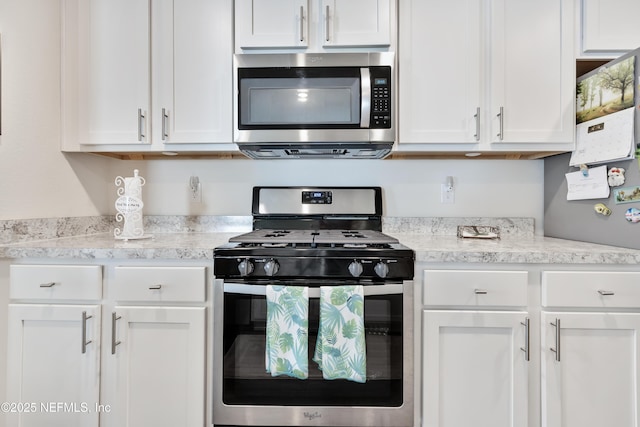 36 Grand Par Ct, Bunnell, FL 32110 - kitchen with appliances with stainless steel finishes, light countertops, and white cabinets