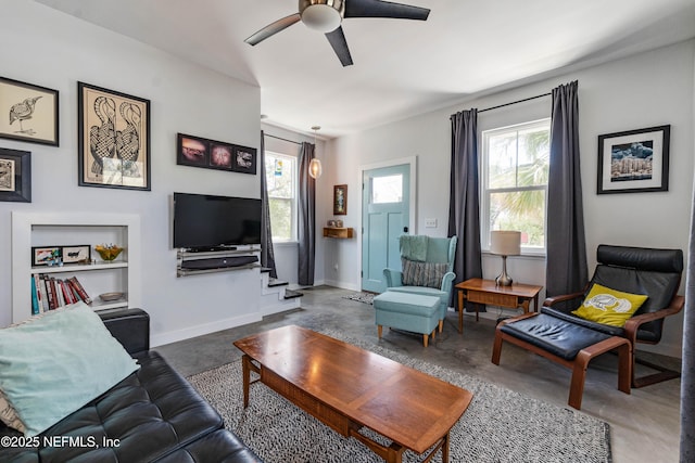 171 Twine St, Saint Augustine, FL 32084 - living area featuring finished concrete flooring, a ceiling fan, baseboards, and stairway