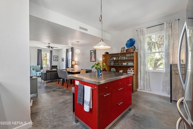 171 Twine St, Saint Augustine, FL 32084 - kitchen featuring stainless steel countertops, red cabinetry, finished concrete flooring, stainless steel refrigerator, and a ceiling fan