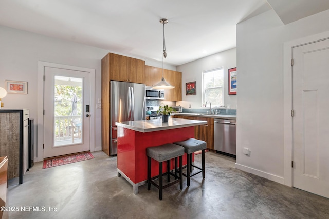 171 Twine St, Saint Augustine, FL 32084 - kitchen with appliances with stainless steel finishes, finished concrete flooring, brown cabinetry, and healthy amount of natural light