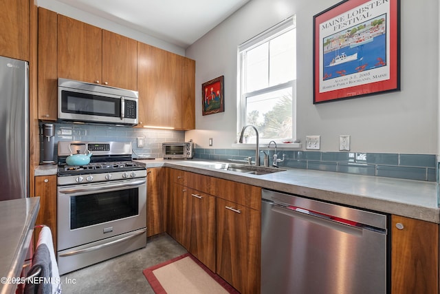171 Twine St, Saint Augustine, FL 32084 - kitchen featuring stainless steel appliances, brown cabinetry, and a sink