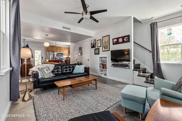 171 Twine St, Saint Augustine, FL 32084 - living room featuring finished concrete flooring, stairs, ceiling fan, and baseboards