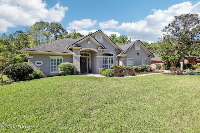 232 Shell Bluff Ct, Ponte Vedra Beach, FL 32082 - view of front facade with stucco siding, a front yard, and a shingled roof