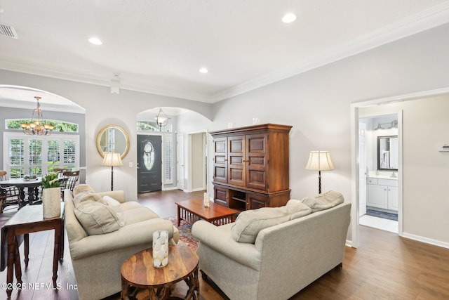 232 Shell Bluff Ct, Ponte Vedra Beach, FL 32082 - living area featuring arched walkways, a chandelier, dark wood finished floors, ornamental molding, and recessed lighting