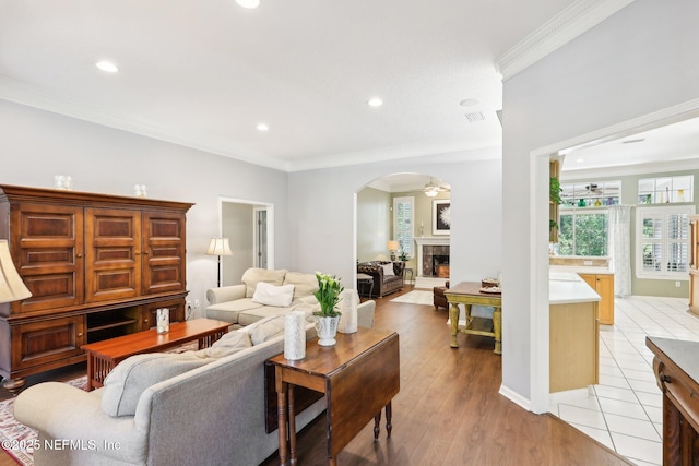 232 Shell Bluff Ct, Ponte Vedra Beach, FL 32082 - living room with arched walkways, a fireplace with raised hearth, crown molding, ceiling fan, and recessed lighting