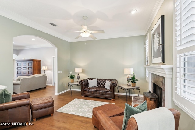 232 Shell Bluff Ct, Ponte Vedra Beach, FL 32082 - living room featuring ceiling fan, arched walkways, a fireplace, wood finished floors, and ornamental molding