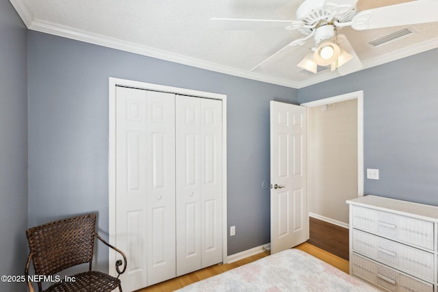 232 Shell Bluff Ct, Ponte Vedra Beach, FL 32082 - bedroom featuring wood finished floors, a closet, ornamental molding, a ceiling fan, and baseboards