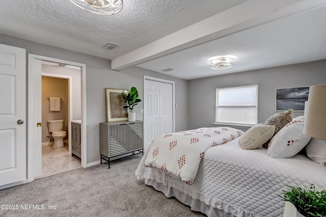 5916 Redberry Ln, Jacksonville, FL 32211 - carpeted bedroom featuring a textured ceiling, beam ceiling, ensuite bathroom, and a closet