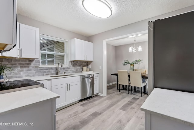 5916 Redberry Ln, Jacksonville, FL 32211 - kitchen with appliances with stainless steel finishes, decorative backsplash, a textured ceiling, white cabinets, and light countertops