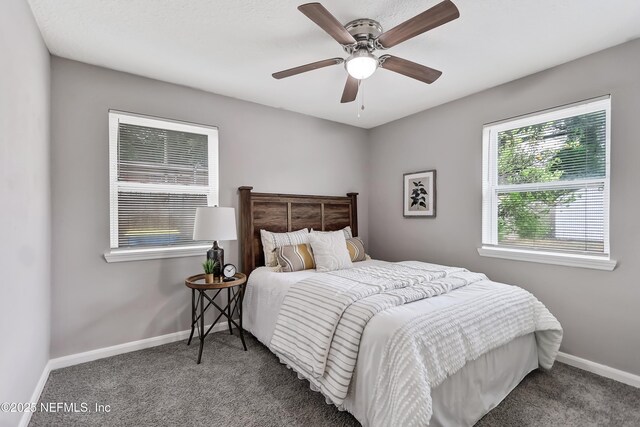 5916 Redberry Ln, Jacksonville, FL 32211 - carpeted bedroom with baseboards and ceiling fan
