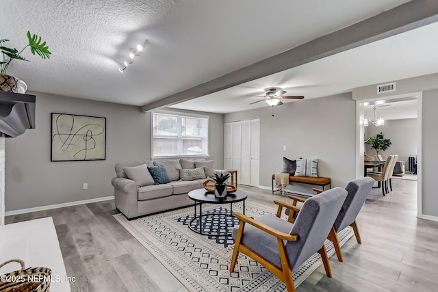 5916 Redberry Ln, Jacksonville, FL 32211 - living room with ceiling fan, wood finished floors, and a textured ceiling