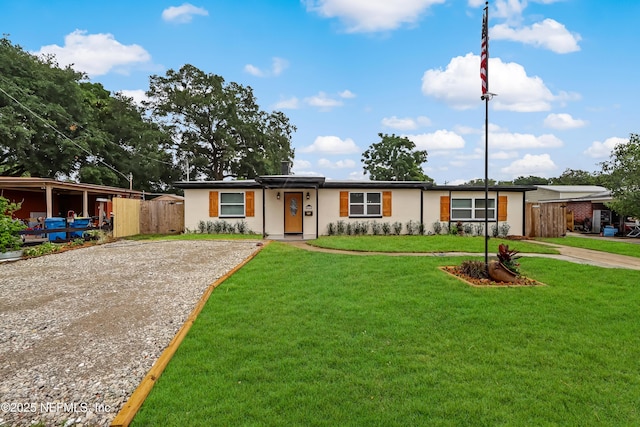 5916 Redberry Ln, Jacksonville, FL 32211 - ranch-style house with gravel driveway and stucco siding