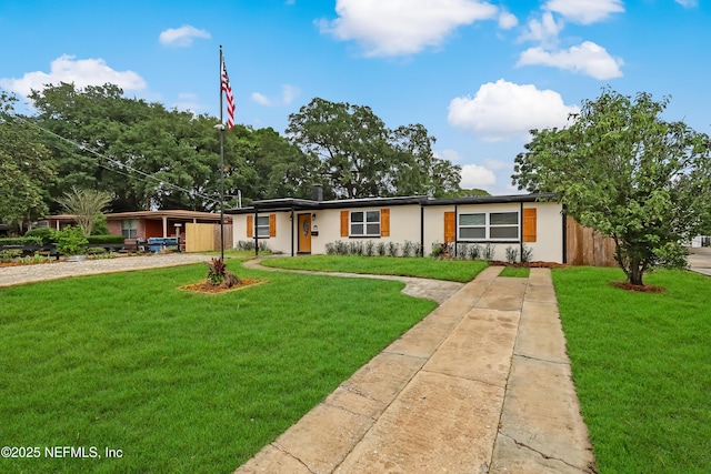 5916 Redberry Ln, Jacksonville, FL 32211 - view of front of house with driveway, a front yard, and stucco siding