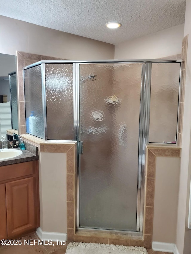 2840 Blackberry Ave, Middleburg, FL 32068 - bathroom featuring vanity, a stall shower, and a textured ceiling