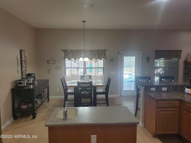2840 Blackberry Ave, Middleburg, FL 32068 - dining space with light tile patterned floors, a chandelier, and baseboards