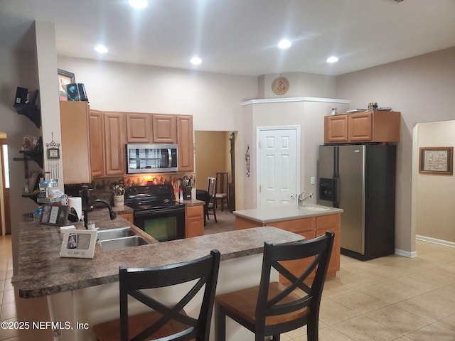 2840 Blackberry Ave, Middleburg, FL 32068 - kitchen with appliances with stainless steel finishes, a sink, light tile patterned floors, a peninsula, and recessed lighting