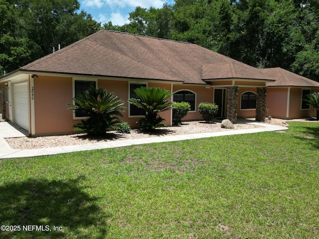 2840 Blackberry Ave, Middleburg, FL 32068 - view of front of home featuring a shingled roof, stucco siding, concrete driveway, and a front yard