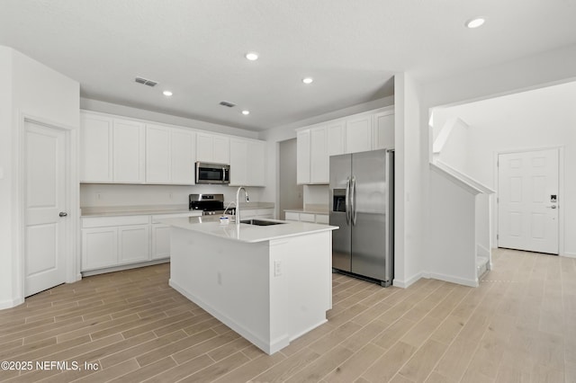 9053 Whinny Way, Jacksonville, FL 32219 - kitchen with appliances with stainless steel finishes, a sink, light wood-style floors, a center island with sink, and recessed lighting